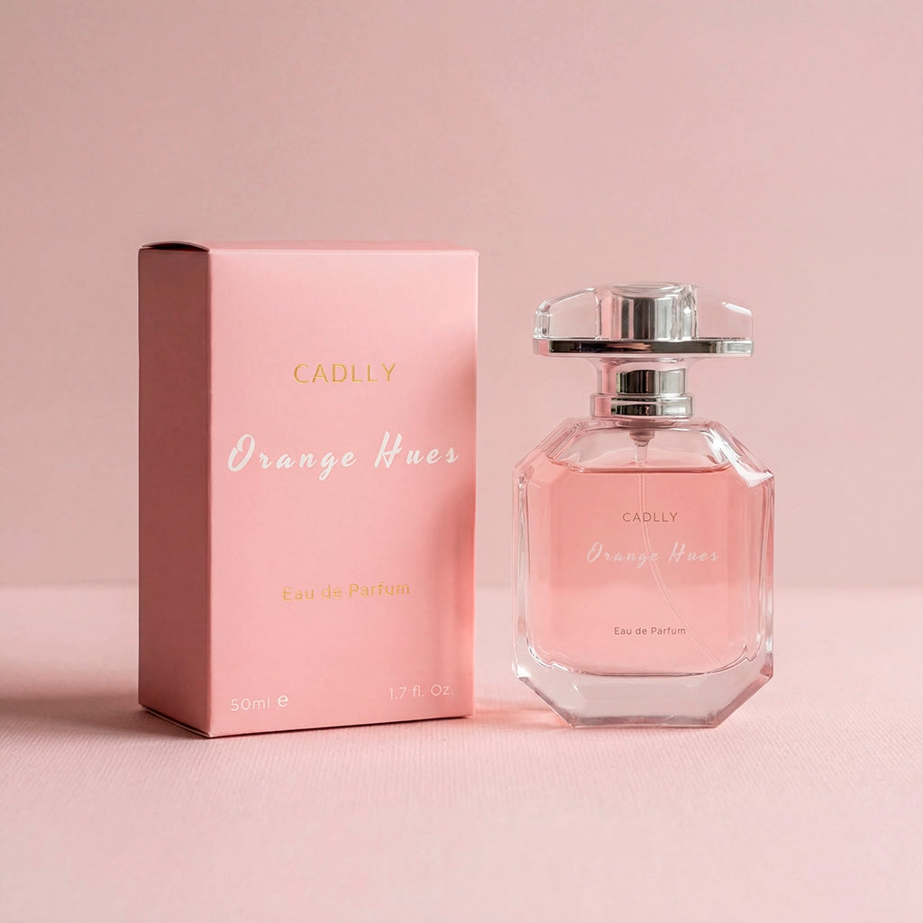 CADLLY Orange Hues perfume bottle and packaging on a pink background