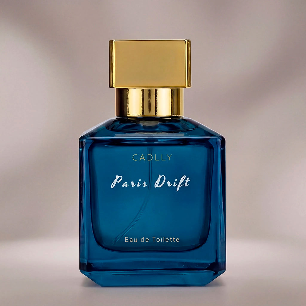 Blue perfume bottle with gold cap on a neutral background