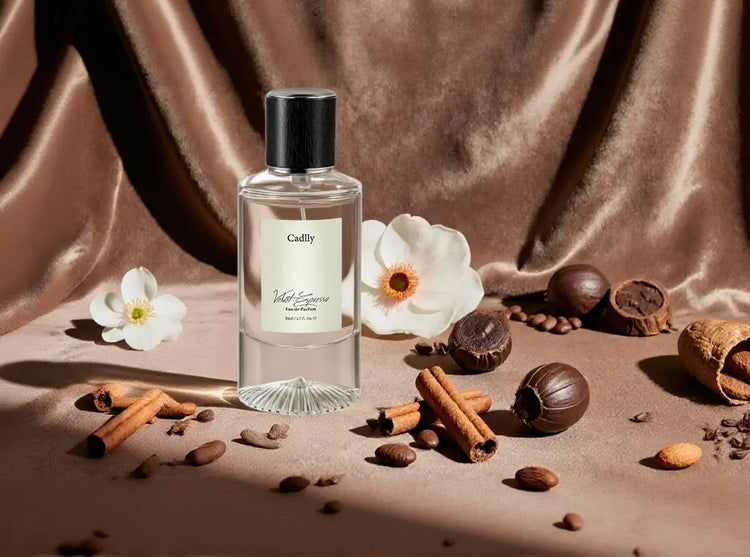 CADLLY Velvet Espresso perfume bottle labeled 'Caffly' with flowers, cinnamon sticks, and chestnuts on a brown fabric background