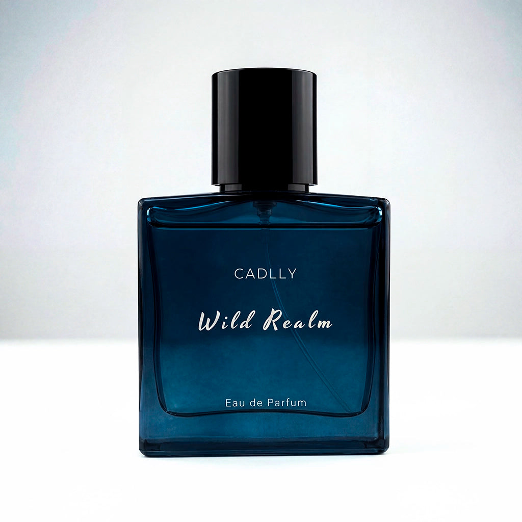 Blue perfume bottle labeled 'Wild Realm' by CADLLY on a white background