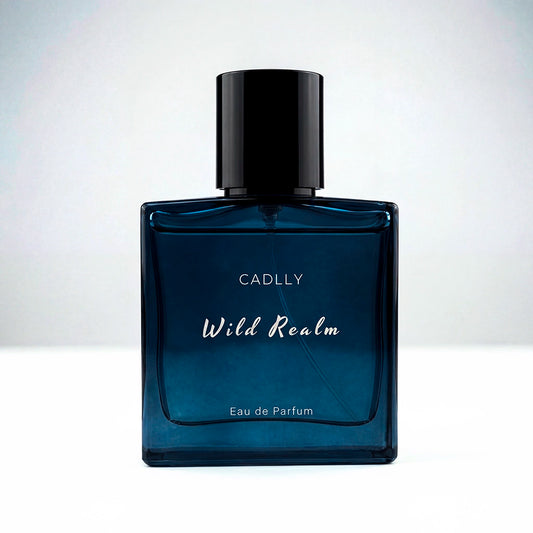 Blue perfume bottle labeled 'Wild Realm' by CADLLY on a white background